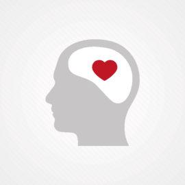 Piirros, jossa on ihmisen pään profiili harmaalla. Aivot ovat valkoisella ja niiden sisällä on punainen sydän.